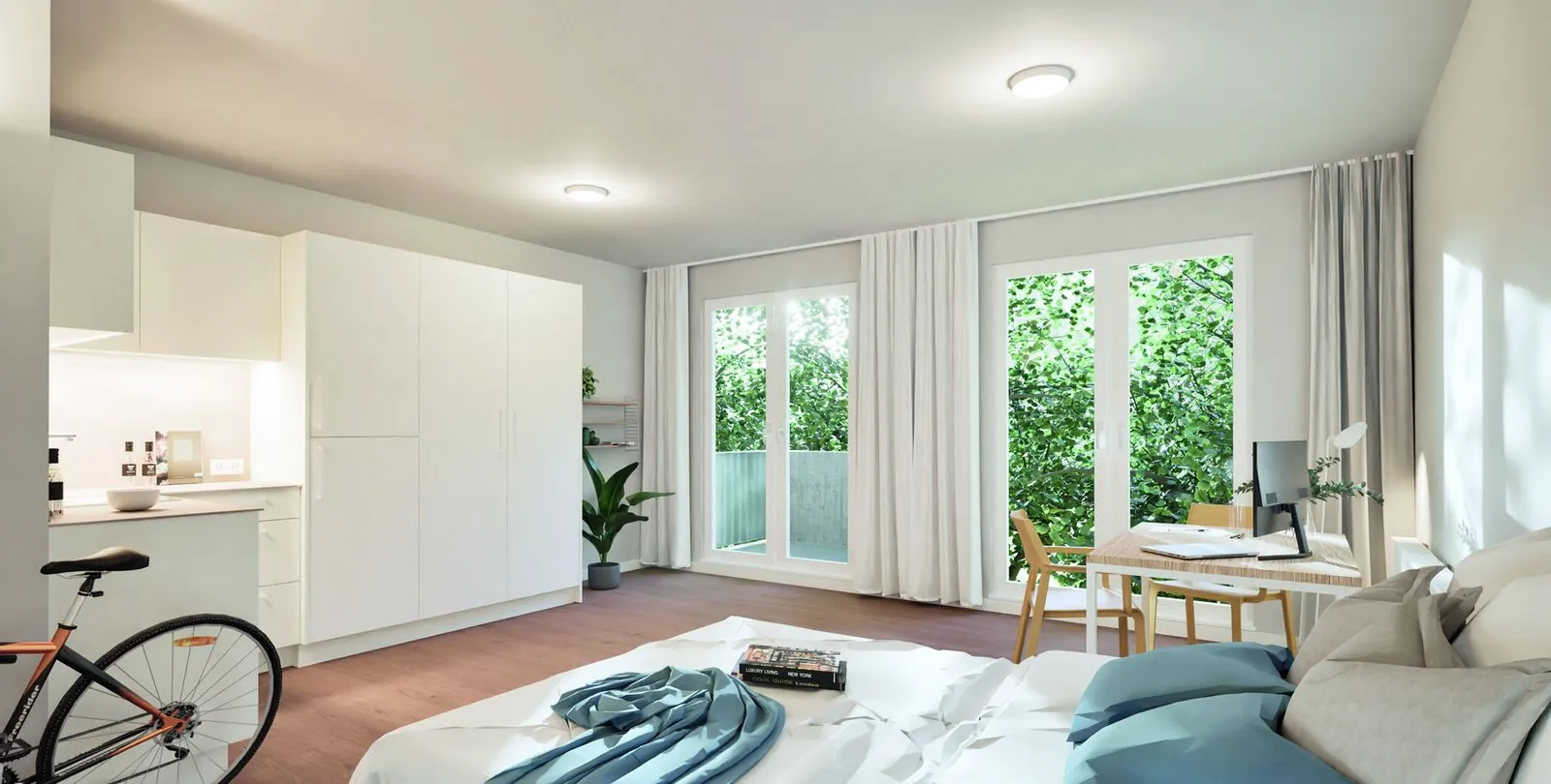 Helles, möbliertes Apartment mit Küchenzeile, Bett, Schreibtisch und Balkontüren ins Grüne